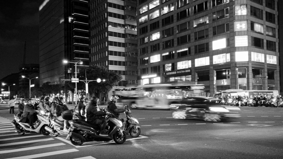Photo by Rei Kim a group of people riding motorcycles down a street